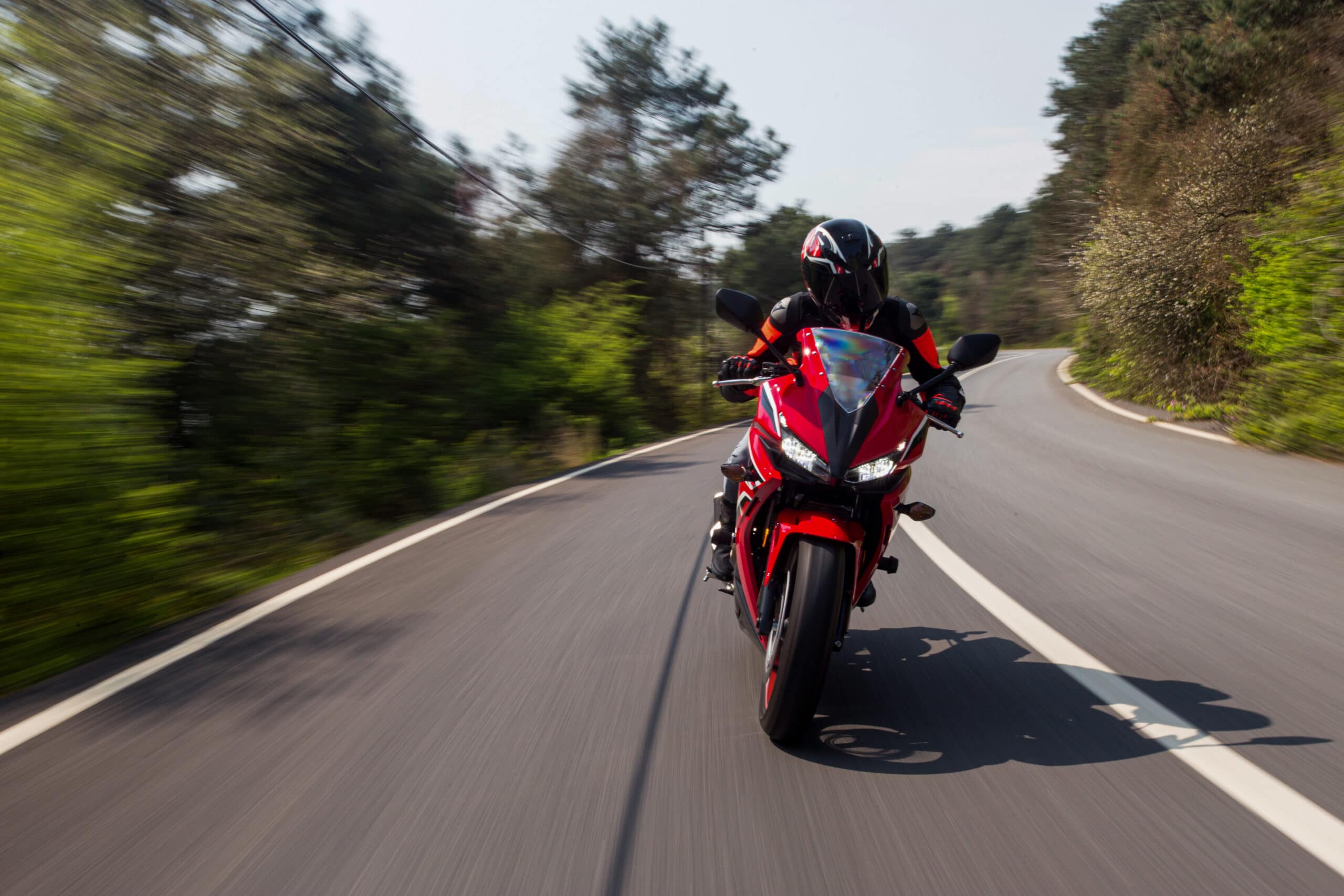 red-motorcycle-driving-on-the-road